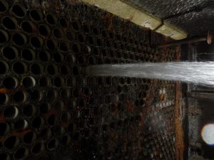 Tube Being Flushed of Debris During Tube Cleaning